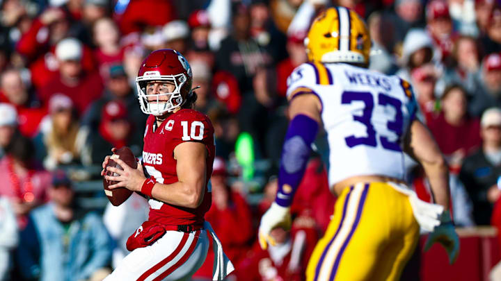 Nov 29, 2025; Norman, Oklahoma, USA;  Oklahoma Sooners quarterback John Mateer (10) throws as Louisiana State Tigers linebacker West Weeks (33) defends during the first half at Gaylord Family-Oklahoma Memorial Stadium. Mandatory Credit: Kevin Jairaj-Imagn Images