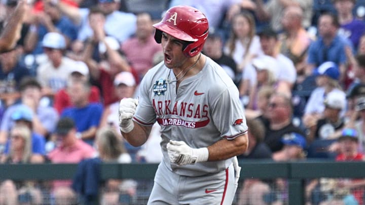 Jun 18, 2025; Omaha, Neb, USA;  Arkansas Razorbacks catcher Ryder Helfrick (27) circles the bases after hitting a home run against the LSU Tigers during the fourth inning at Charles Schwab Field. Mandatory Credit: Steven Branscombe-Imagn Images
