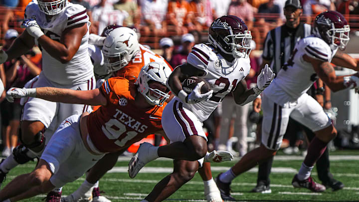 Mississippi State running back Davon Booth (21) runs the ball against the Texas Longhorns at Darrell K Royal-Texas Memorial Stadium in Austin Saturday, Sept. 28, 2024.