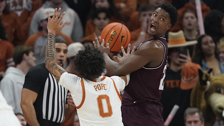Texas A&M Aggies forward Pharrel Payne (21) looks to pass the ball while defended by Texas Longhorns guard Jordan Pope (0) during the first half at Moody Center.