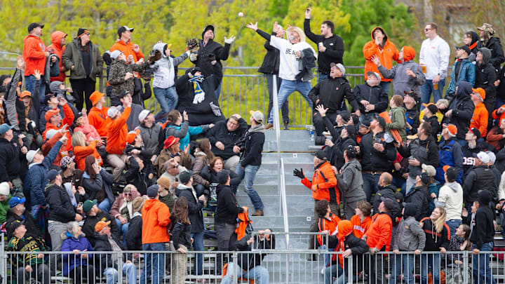 Beaver fans attempt to catch Oregon State's BradyÊKasperÊ(17) home run duringÊthe NCAA college baseball game at Goss Stadium on Friday,ÊApril 26, 2024, in Corvallis, Ore.