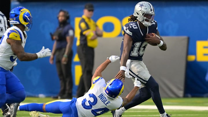 Dallas Cowboys quarterback Joe Milton III gets past Los Angeles Rams safety Tanner Ingle