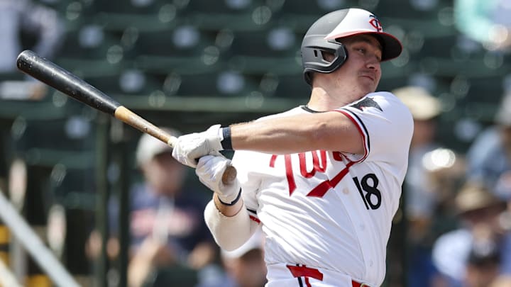 Mar 4, 2026; Fort Myers, Florida, USA; Minnesota Twins center fielder Alan Roden (18) triples against Puerto Rico in the second inning during spring training at Lee Health Sports Complex/Hammond Stadium.