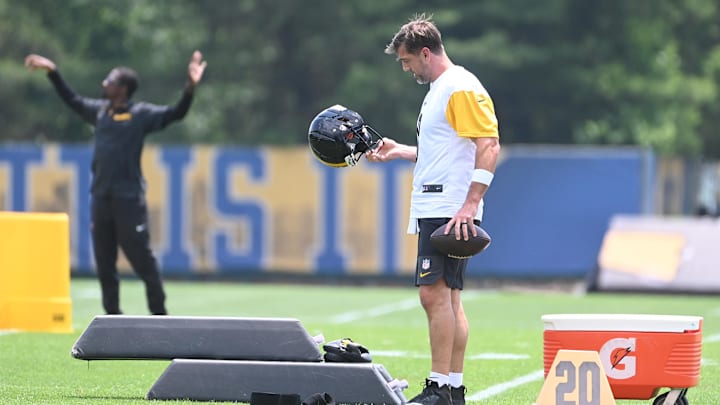 Jun 10, 2025; Pittsburgh, PA, USA;  Pittsburgh Steelers quarterback Aaron Rodgers (8) looks over his helmet during minicamp at their South Side facility. Mandatory Credit: Philip G. Pavely-Imagn Images