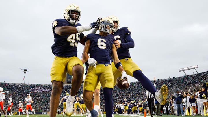 Notre Dame defensive lineman Kobi Onyiuke (45), wide receiver Jordan Faison (6) and wide receiver Alex Whitman (86) celebrate a Faison touchdown on fake punt play that would later be called back during a NCAA college football game against Virginia at Notre Dame Stadium on Saturday, Nov. 16, 2024, in South Bend.