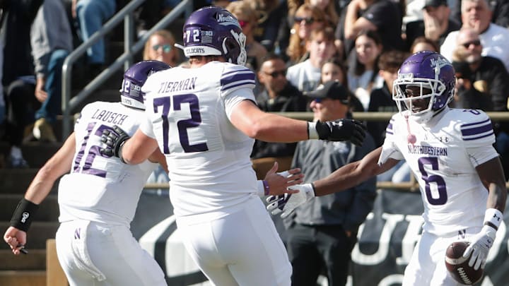 Northwestern Wildcats running back Joseph Himon II (6) celebrates with Northwestern Wildcats quarterback Jack Lausch (12) and Northwestern Wildcats offensive lineman Caleb Tiernan (72) after scoring Saturday, Nov. 2, 2024, during the NCAA football game against the Purdue Boilermakers at Ross-Ade Stadium in West Lafayette, Ind.
