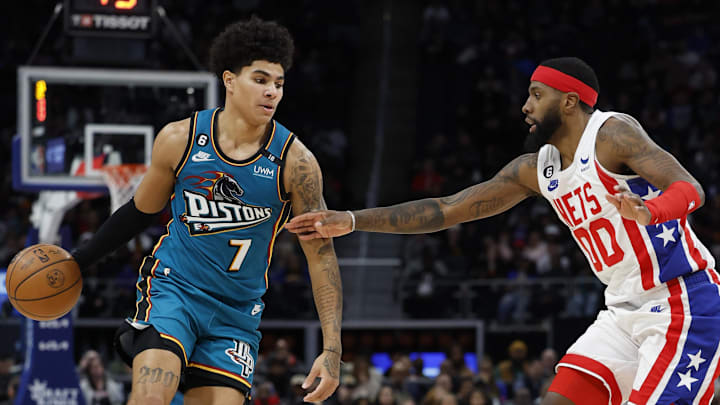 Dec 18, 2022; Detroit, Michigan, USA; Detroit Pistons guard Killian Hayes (7) dribbles defended by Brooklyn Nets forward Royce O'Neale (00) in the second half at Little Caesars Arena. Mandatory Credit: Rick Osentoski-Imagn Images