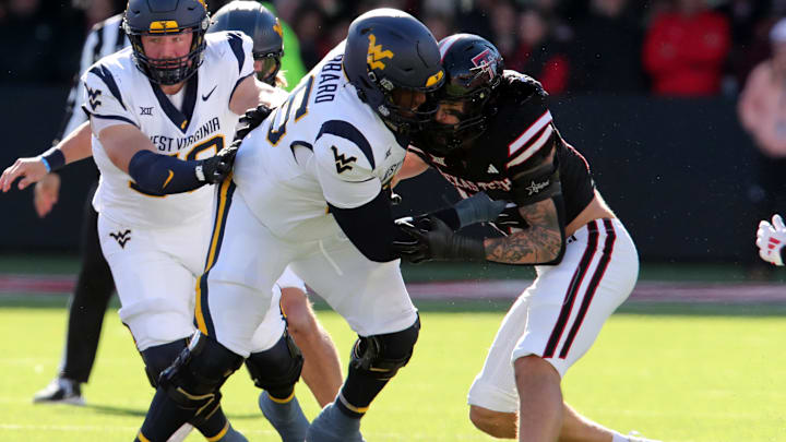 Nov 30, 2024; Lubbock, Texas, USA;  West Virginia Mountaineers offensive lineman Ja’Quay Hubbard (66) blocks Texas Tech Red Raiders Charles Esters III (11) in the first half fat Jones AT&T Stadium and Cody Campbell Field. Mandatory Credit: Michael C. Johnson-Imagn Images