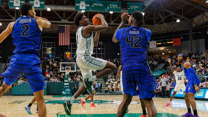 Jan 30, 2025; New Orleans, Louisiana, USA; Tulane Green Wave forward Kaleb Banks (1) drives to the basket against Memphis Tigers forward Dain Dainja (42) during the second half at Avron B. Fogelman Arena in Devlin Fieldhouse. Jan 30, 2025; New Orleans, Louisiana, USA; Tulane Green Wave forward Kaleb Banks (1) drives to the basket against Memphis Tigers forward Dain Dainja (42) during the second half at Avron B. Fogelman Arena in Devlin Fieldhouse.