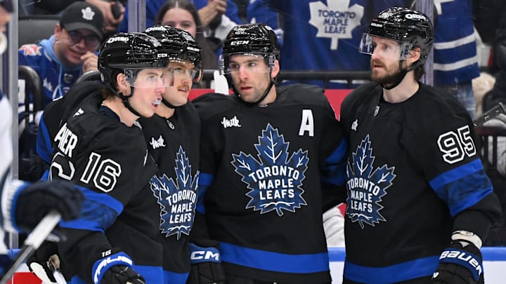 Dec 23, 2024; Toronto, Ontario, CAN;  Toronto Maple Leafs forward John Tavares (91) celebrates with forwards Mitch Marner (16) and William Nylander (88) and defenseman Oliver Ekman-Larsson (95) after scoring a goal against the Winnipeg Jets in the third period at Scotiabank Arena. Mandatory Credit: Dan Hamilton-Imagn Images