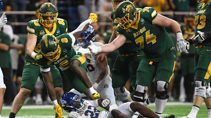 Grey Zabel (74) tries to lend a hand to running back Barika Kpeenu  in a game against South Dakota State.