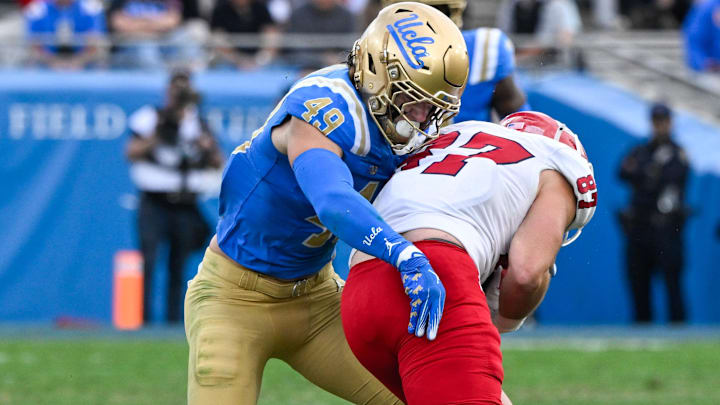 Nov 30, 2024; Pasadena, California, USA; UCLA Bruins linebacker Carson Schwesinger (49) Fresno State Bulldogs tight end Jake Tarwater (87) during the third quarter at Rose Bowl. Mandatory Credit: Robert Hanashiro-Imagn Images