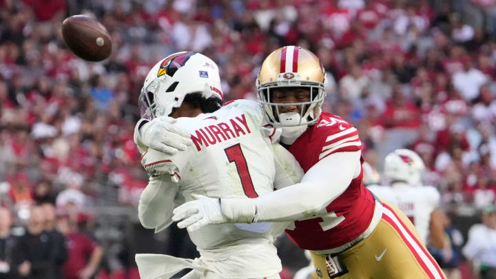 Dec 17, 2023; Glendale, Ariz, United States; Arizona Cardinals quarterback Kyler Murray (1) delivers a pass while hit by San Francisco 49ers defensive end Clelin Ferrell (94) during the third quarter at State Farm Stadium. Mandatory Credit: Michael Chow-Arizona Republic