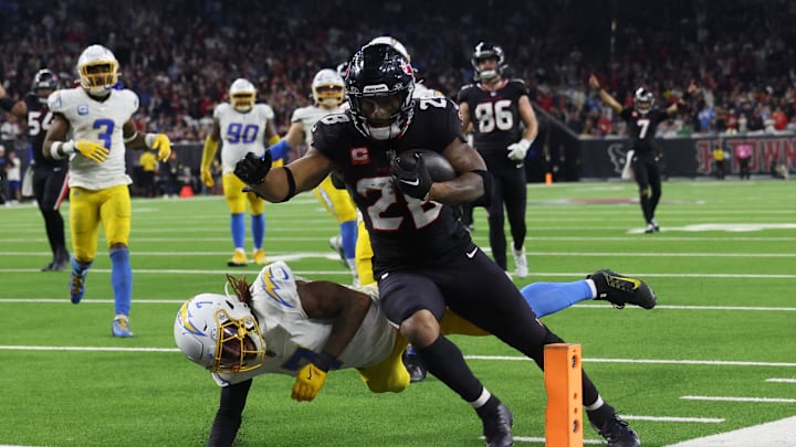 Jan 11, 2025; Houston, Texas, USA;  Houston Texans running back Joe Mixon (28) scores a touchdown against the Los Angeles Chargers in the fourth quarter in an AFC wild card game at NRG Stadium. Mandatory Credit: Thomas Shea-Imagn Images