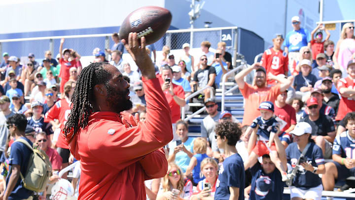 Jul 26, 2024; Foxborough, MA, USA; New England Patriots linebacker Matthew Judon (9) tosses a ball to fans during training camp at Gillette Stadium. Mandatory Credit: Eric Canha-USA TODAY Sports