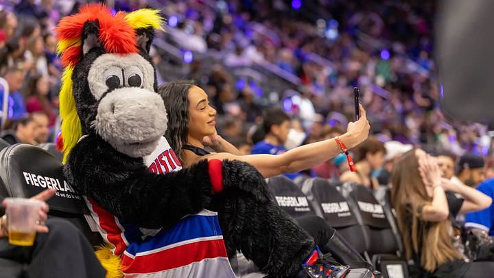 Mar 31, 2026; Detroit, Michigan, USA; Hooper the Detroit Pistons Mascot get busy with fan during the second half of the game against the Toronto Raptors at Little Caesars Arena. Mandatory Credit: David Reginek-Imagn Images Mar 31, 2026; Detroit, Michigan, USA; Hooper the Detroit Pistons Mascot get busy with fan during the second half of the game against the Toronto Raptors at Little Caesars Arena. Mandatory Credit: David Reginek-Imagn Images