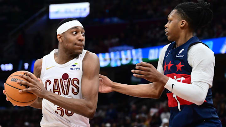 Apr 12, 2026; Cleveland, Ohio, USA; Cleveland Cavaliers forward Nae'qwan Tomlin (35) drives to the basket against Washington Wizards guard Bub Carrington (7) during the second half at Rocket Arena. Mandatory Credit: Ken Blaze-Imagn Images