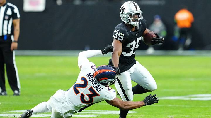 Jan 7, 2024; Paradise, Nevada, USA; Las Vegas Raiders running back Zamir White (35) breaks the tackle of Denver Broncos cornerback Fabian Moreau (23) during the second quarter at Allegiant Stadium. Mandatory Credit: Stephen R. Sylvanie-USA TODAY Sports Jan 7, 2024; Paradise, Nevada, USA; Las Vegas Raiders running back Zamir White (35) breaks the tackle of Denver Broncos cornerback Fabian Moreau (23) during the second quarter at Allegiant Stadium. Mandatory Credit: Stephen R. Sylvanie-USA TODAY Sports