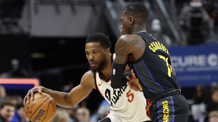 Jan 9, 2025; Detroit, Michigan, USA;  Detroit Pistons guard Malik Beasley (5) dribbles against Golden State Warriors guard Dennis Schroder (71) in the first half at Little Caesars Arena. Mandatory Credit: Rick Osentoski-Imagn Images