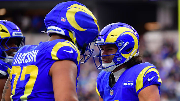 Jan 4, 2026; Inglewood, California, USA; Los Angeles Rams wide receiver Puka Nacua (12) reacts with offensive tackle Alaric Jackson (77) after a touchdown catch. against the Arizona Cardinals during the first half at SoFi Stadium. Mandatory Credit: Gary A. Vasquez-Imagn Images