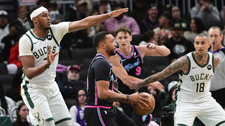 Feb 24, 2026; Milwaukee, Wisconsin, USA;  Miami Heat guard Norman Powell (24) looks for a shot against Milwaukee Bucks center Myles Turner (3) and forward Kyle Kuzma (18) in the first quarter at Fiserv Forum. Mandatory Credit: Benny Sieu-Imagn Images