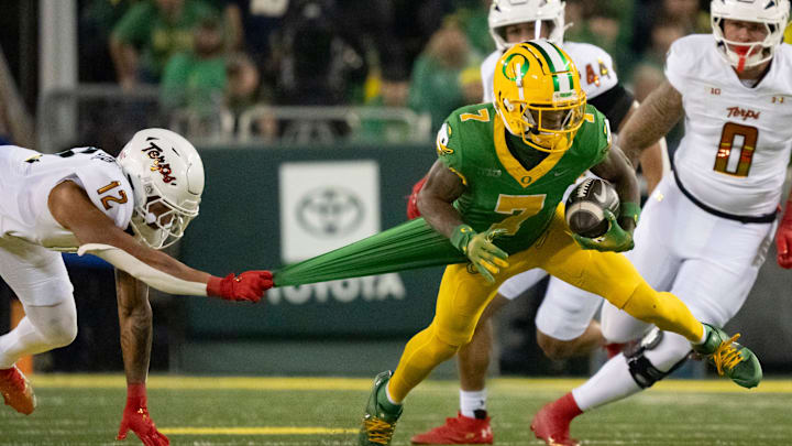 Oregon wide receiver Evan Stewart attempts to avoid a tackle from Maryland defensive back Dante Trader Jr. as the Oregon Ducks host the Maryland Terrapins at Autzen Stadium Saturday, Nov. 9, 2024 in Eugene, Ore.