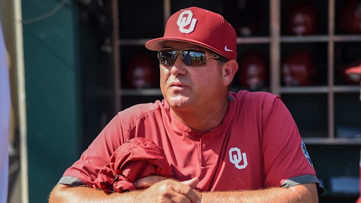 Jun 25, 2022; Omaha, NE, USA;  Oklahoma Sooners head coach Skip Johnson looks over the field before the game against the Ole Miss Rebels at Charles Schwab Field. Mandatory Credit: Steven Branscombe-Imagn Images