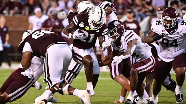 Aug 31, 2024; Starkville, Mississippi, USA;  Mississippi State Bulldogs running back Davon Booth (21) runs the ball against Eastern Kentucky Colonels defensive back Sam Robertson (24) during the third quarter at Davis Wade Stadium at Scott Field. Mandatory Credit: Matt Bush-Imagn Images