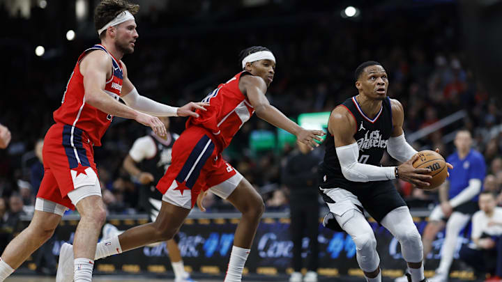Jan 31, 2024; Washington, District of Columbia, USA; LA Clippers guard Russell Westbrook (0) drives to the basket as Washington Wizards guard Bilal Coulibaly (0) and Wizards forward Corey Kispert (24) defend in the second half at Capital One Arena. Mandatory Credit: Geoff Burke-Imagn Images