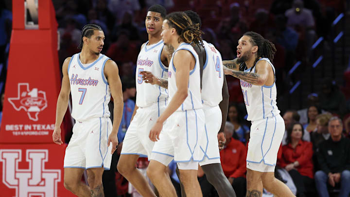 Jan 13, 2026; Houston, Texas, USA;  Houston Cougars guard Milos Uzan (7) leads his teammates out onto the floor after a West Virginia Mountaineers timeout in the first half at Fertitta Center.