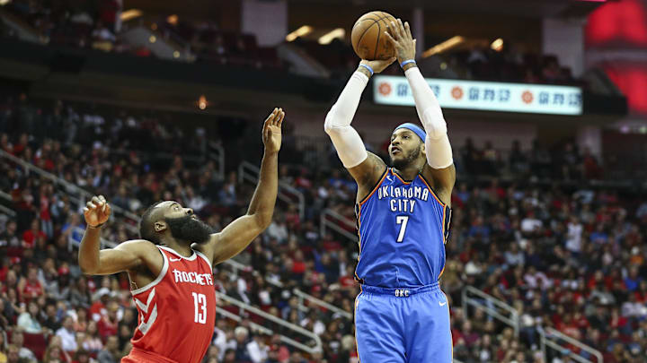 Apr 7, 2018; Houston, TX, USA; Oklahoma City Thunder forward Carmelo Anthony (7) shoots the ball as Houston Rockets guard James Harden (13) defends during the third quarter at Toyota Center. Mandatory Credit: Troy Taormina-Imagn Images