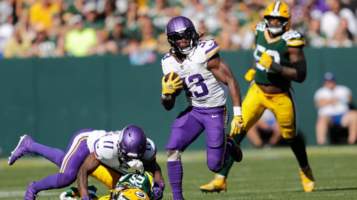 Minnesota Vikings running back Aaron Jones (33) runs for a gain against the Green Bay Packers during their football game Sunday, September 29, 2024, at Lambeau Field in Green Bay, Wisconsin.