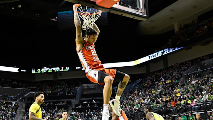 Jan 2, 2025; Eugene, Oregon, USA; Illinois Fighting Illini guard Tre White (22) dunks the ball against the Oregon Ducks during the second half at Matthew Knight Arena. Mandatory Credit: Craig Strobeck-Imagn Images