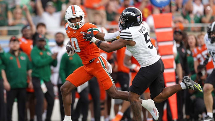 Dec 28, 2024; Orlando, FL, USA; Miami Hurricanes wide receiver Joshisa Trader (0) holds off Iowa State Cyclones defensive back Myles Purchase (5) in the second quarter during the Pop Tarts bowl at Camping World Stadium. Mandatory Credit: Nathan Ray Seebeck-Imagn Images Dec 28, 2024; Orlando, FL, USA; Miami Hurricanes wide receiver Joshisa Trader (0) holds off Iowa State Cyclones defensive back Myles Purchase (5) in the second quarter during the Pop Tarts bowl at Camping World Stadium. Mandatory Credit: Nathan Ray Seebeck-Imagn Images