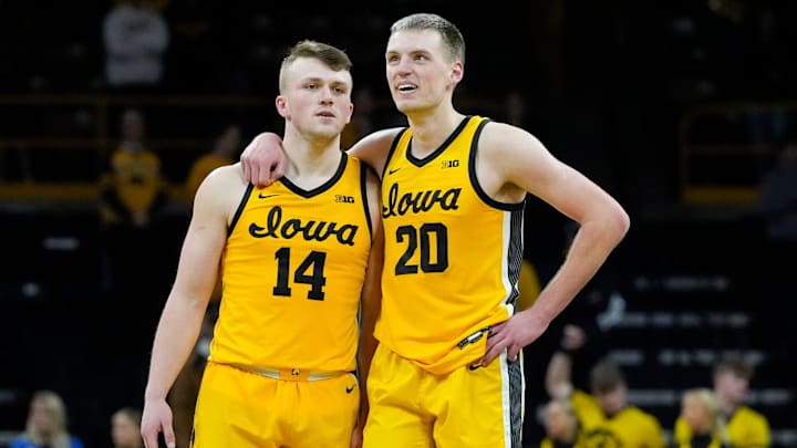 Iowa Hawkeyes guard Carter Kingsbury (14) and Iowa Hawkeyes forward Payton Sandfort (20) stand together as free throws are shot against the Washington Huskies Saturday, Feb. 22, 2025 at Carver-Hawkeye Arenain Iowa City, Iowa.