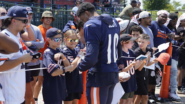 Bears receiver Tyler Scott signs autographs at Halas Hall during training camp. The Bears will report this year July 22.