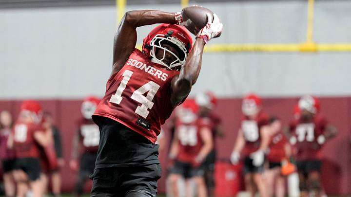 Elijah Thomas (14) runs drills during an Oklahoma football practice. Elijah Thomas (14) runs drills during an Oklahoma football practice.