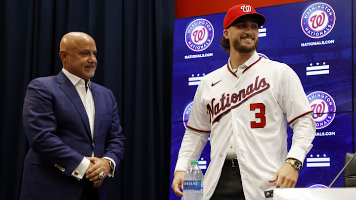 Jul 22, 2023; Washington, District of Columbia, USA; Washington Nationals president of baseball operations and general manager Mike Rizzo (L) looks on as Nationals first round draft pick outfielder Dylan Crews (R) wears his cap and jersey at an introductory press conference prior to the Nationals' game against the San Francisco Giants at Nationals Park. 
