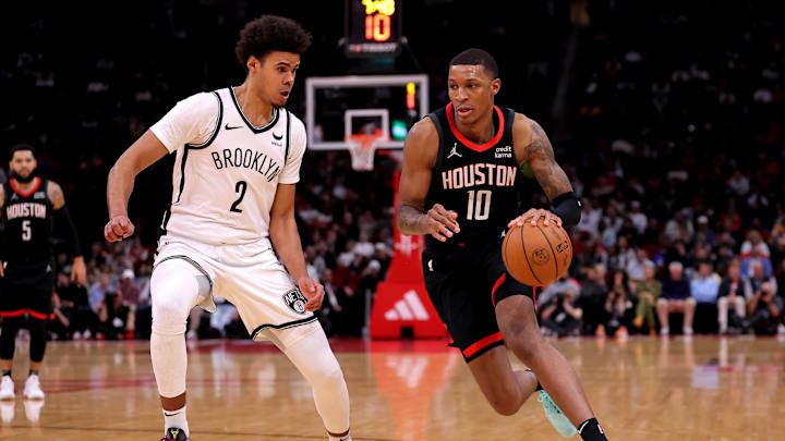 Jan 3, 2024; Houston, Texas, USA; Houston Rockets forward Jabari Smith Jr. (10) handles the ball against Brooklyn Nets forward Cameron Johnson (2) during the third quarter at Toyota Center. Mandatory Credit: Erik Williams-Imagn Images