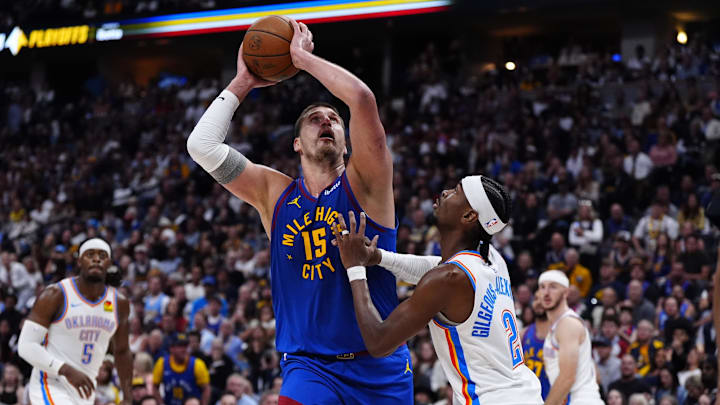 May 9, 2025; Denver, Colorado, USA; Oklahoma City Thunder guard Shai Gilgeous-Alexander (2) defends on Denver Nuggets center Nikola Jokic (15) in the second half during game three of the second round for the 2025 NBA Playoffs at Ball Arena. Mandatory Credit: Ron Chenoy-Imagn Images