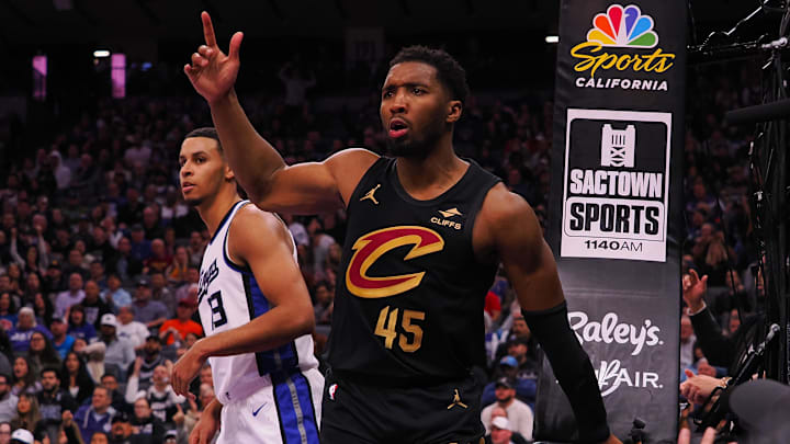 Mar 19, 2025; Sacramento, California, USA; Cleveland Cavaliers guard Donovan Mitchell (45) looks for a goaltending call against Sacramento Kings forward Keegan Murray (13) during the fourth quarter at Golden 1 Center. Mandatory Credit: Kelley L Cox-Imagn Images