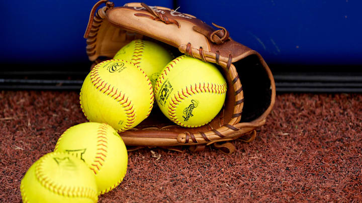 A softball glove with softballs is pictured before Game 1 of the Women's College World Series championship series between the Texas Longhorns at Texas Tech Red Raiders at Devon Park in Oklahoma City, Wednesday, June 4, 2025. Texas won 2-1.