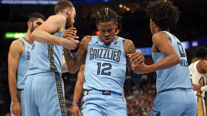 Nov 29, 2024; Memphis, Tennessee, USA; Memphis Grizzlies guard Ja Morant (12) is helped up by center Jay Huff (30) and forward Jaylen Wells (0) during the second quarter against the New Orleans Pelicans at FedExForum. Mandatory Credit: Petre Thomas-Imagn Images Nov 29, 2024; Memphis, Tennessee, USA; Memphis Grizzlies guard Ja Morant (12) is helped up by center Jay Huff (30) and forward Jaylen Wells (0) during the second quarter against the New Orleans Pelicans at FedExForum. Mandatory Credit: Petre Thomas-Imagn Images