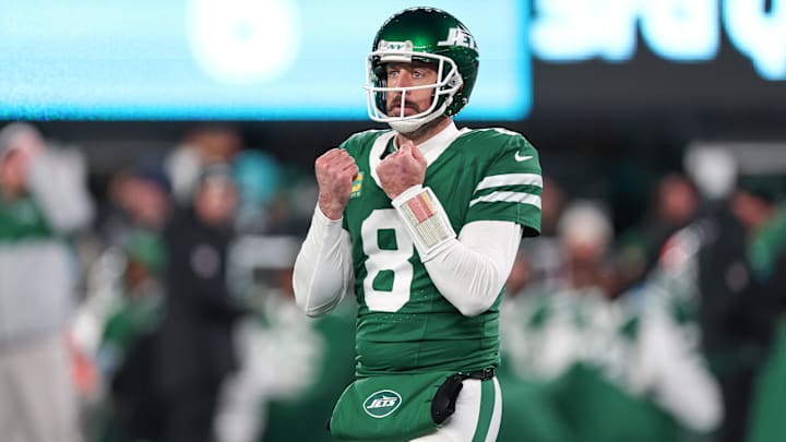 Jan 5, 2025; East Rutherford, New Jersey, USA; New York Jets quarterback Aaron Rodgers (8) gestures towards the Miami Dolphins bench during the second half at MetLife Stadium. Mandatory Credit: Vincent Carchietta-Imagn Images