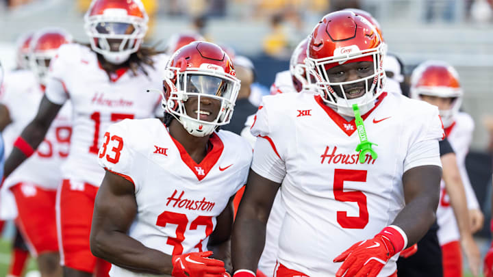 Oct 25, 2025; Tempe, Arizona, USA; Houston Cougars defensive back Johnsley Barbas (33) and defensive lineman Carlos Allen Jr. (5) against the Arizona State Sun Devils at Mountain America Stadium. Mandatory Credit: Mark J. Rebilas-Imagn Images