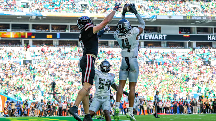 Jan 1, 2026; Miami Gardens, FL, USA; Oregon Ducks defensive back Brandon Finney (4) makes the interception in front of Texas Tech Red Raiders wide receiver Coy Eakin (3) during the second half of the 2025 Orange Bowl and quarterfinal game of the College Football Playoff at Hard Rock Stadium. Mandatory Credit: Nathan Ray Seebeck-Imagn Images