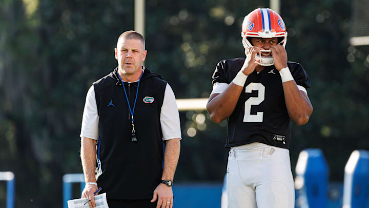 Florida Gators head coach Billy Napier and Florida Gators quarterback DJ Lagway (2) watch during spring football practice at Heavener Football Complex at the University of Florida in Gainesville, FL on Thursday, March 6, 2025. [Matt Pendleton/Gainesville Sun]