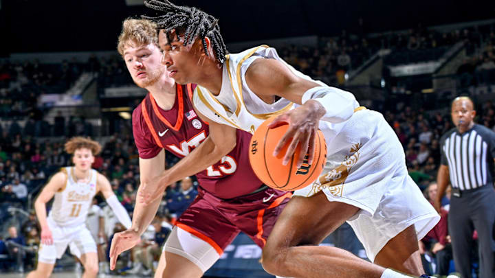 Feb 10, 2024; South Bend, Indiana, USA; Notre Dame Fighting Irish forward Carey Booth (0) dribbles the ball against Virginia Tech Hokies guard Tyler Nickel (23) in the first half at the Purcell Pavilion. Mandatory Credit: Matt Cashore-Imagn Images