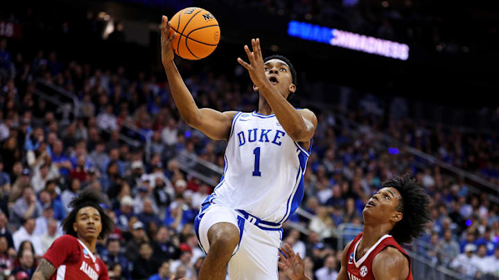 Mar 29, 2025; Newark, NJ, USA; Duke Blue Devils guard Caleb Foster (1) drives to the basket against Alabama Crimson Tide guard Aden Holloway (2) during the first half in the East Regional final of the 2025 NCAA tournament at Prudential Center. Mandatory Credit: Vincent Carchietta-Imagn Images Mar 29, 2025; Newark, NJ, USA; Duke Blue Devils guard Caleb Foster (1) drives to the basket against Alabama Crimson Tide guard Aden Holloway (2) during the first half in the East Regional final of the 2025 NCAA tournament at Prudential Center. Mandatory Credit: Vincent Carchietta-Imagn Images