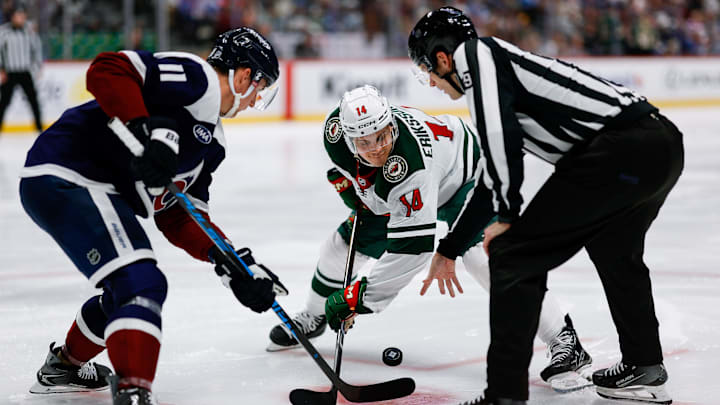 Mar 8, 2026; Denver, Colorado, USA; Colorado Avalanche center Brock Nelson (11) faces off against Minnesota Wild center Joel Eriksson Ek (14) on a puck drop from linesman Joe Mahon (89) in the third period at Ball Arena. Mandatory Credit: Isaiah J. Downing-Imagn Images